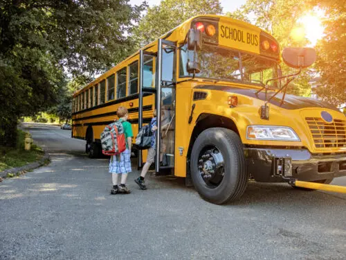 Kids getting on school bus