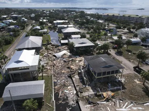Debris from homes swept off their lots chokes a canal amid stilted homes which remain standing, in Horseshoe Beach, Florida, Aug. 31, 2023, one day after the passage of Hurricane Idalia.